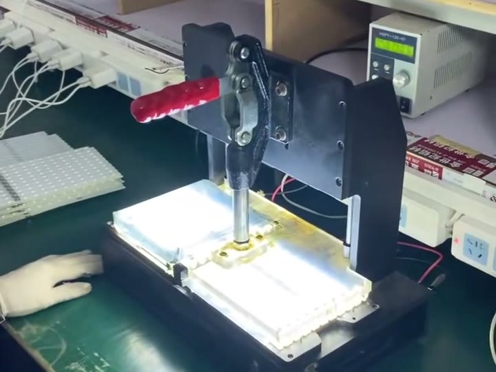 Factory-supplied illuminated fixture station used during a hands-on light check