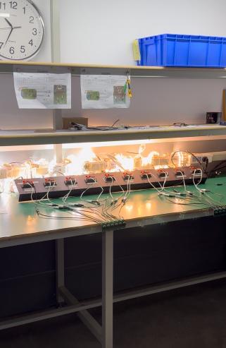 Multiple connected light products illuminated on a factory bench