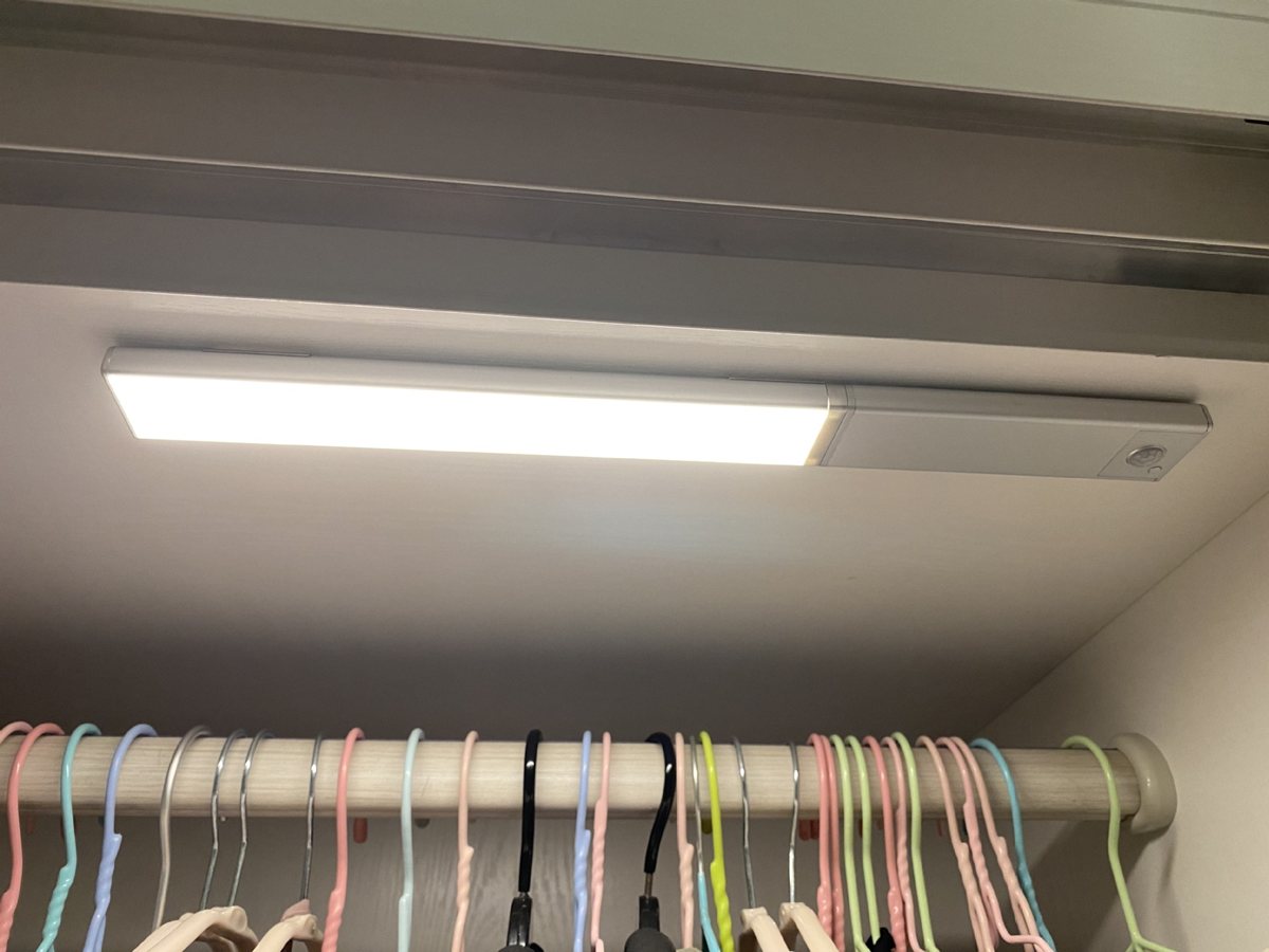 TDL-6111 sensor light bar mounted over a wardrobe hanging rail